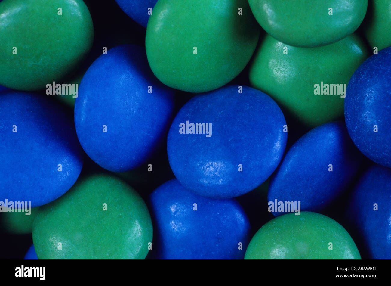 Blue and green sugar coated chocolate sweets Stock Photo Alamy