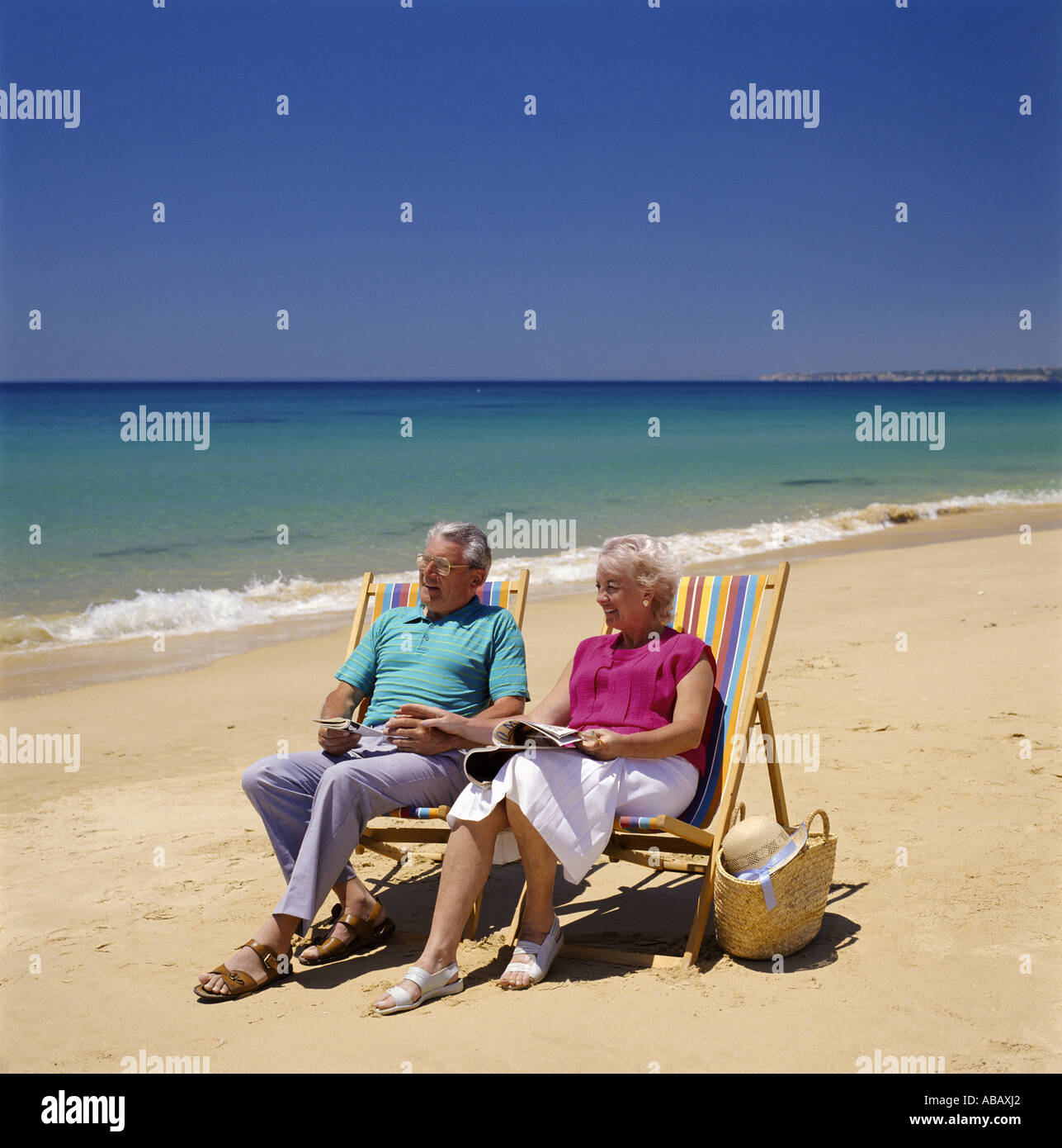Elderly Couple in Deckchairs on Beach Stock Photo - Alamy