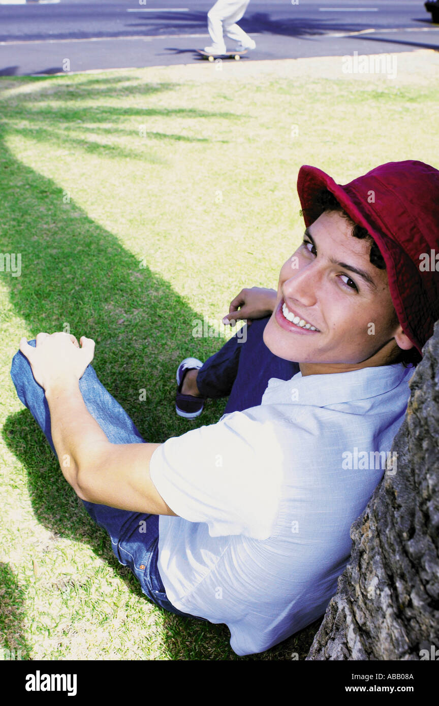 Man leaning against tree Stock Photo