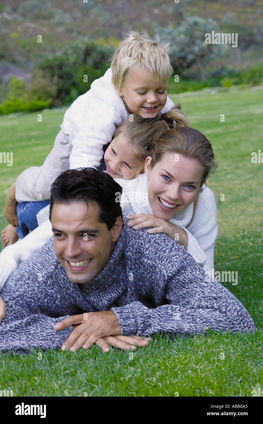 Family lying on the grass Stock Photo