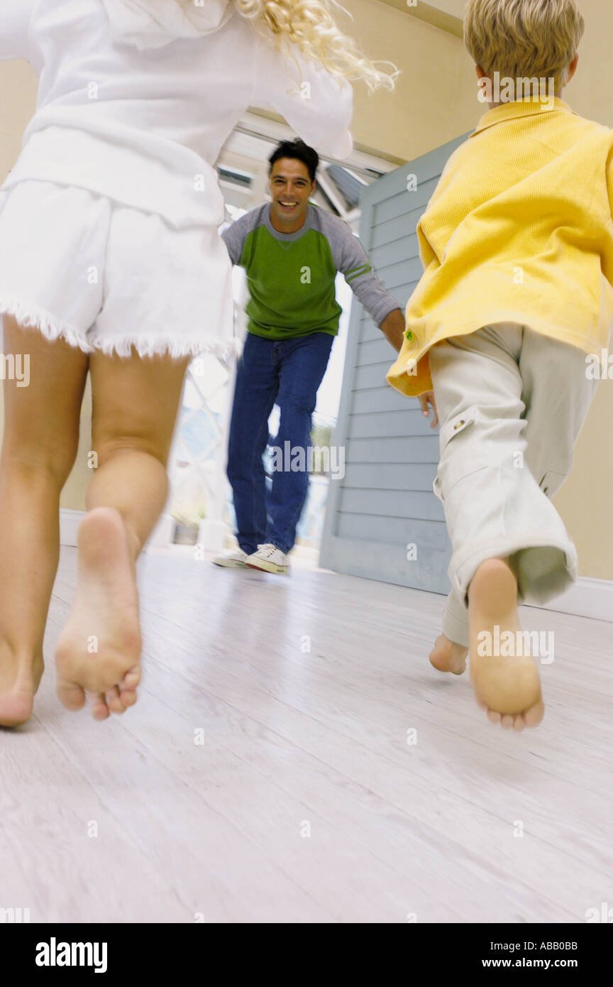 Kids running towards father Stock Photo