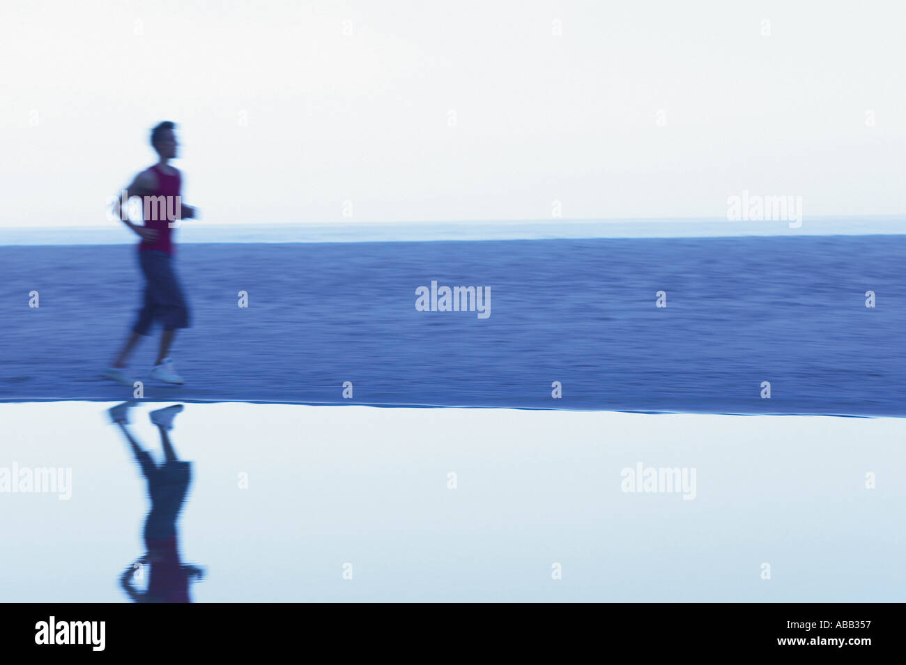 Running Man 357 Male runner sandy beach hi-res stock photography and images - Alamy