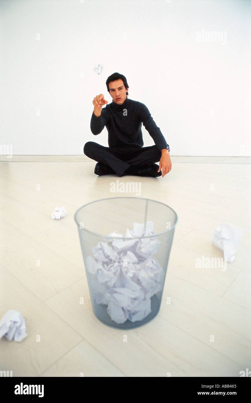 Man throwing paper into bin Stock Photo Alamy