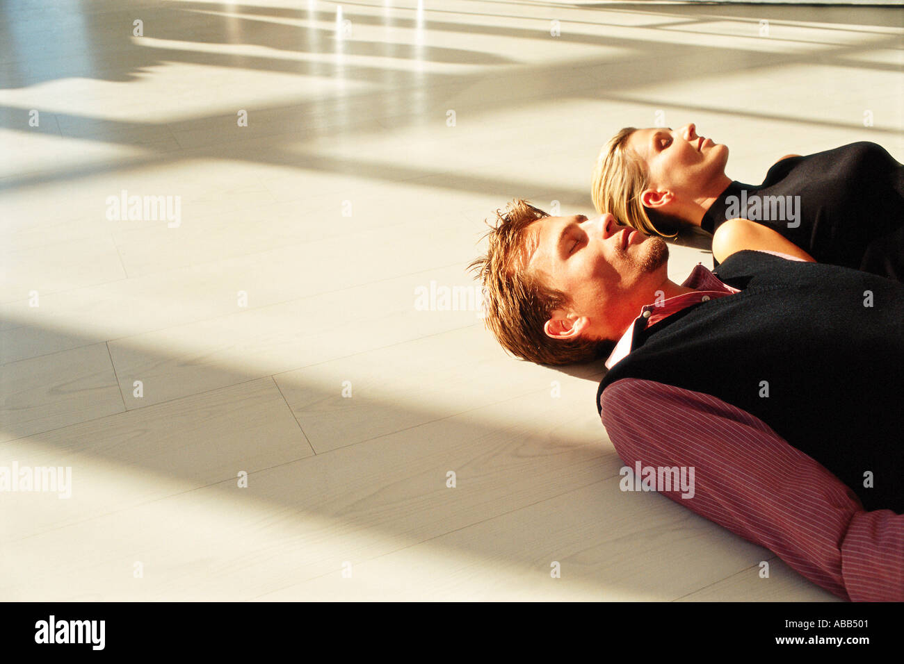 Man and woman lying on floor Stock Photo - Alamy