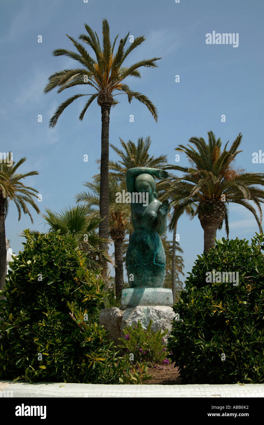 Mermaid sculpture among palm trees, Sitges, Costa Brava Spain Europe Stock Photo