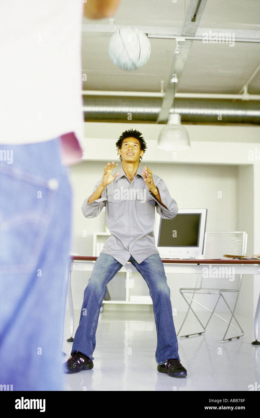 Men playing with ball in an office Stock Photo - Alamy