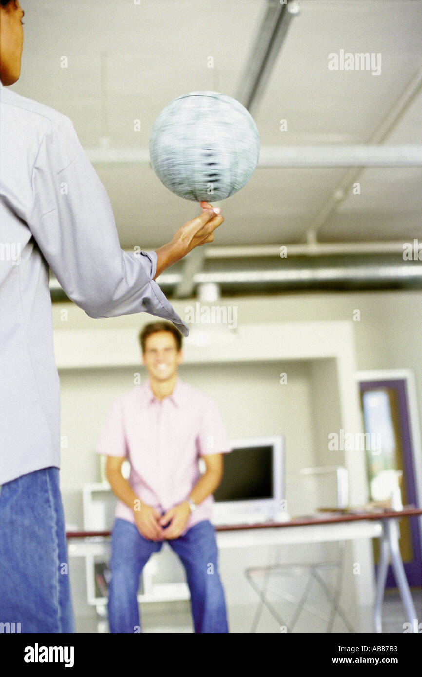 Men playing with ball in an office Stock Photo