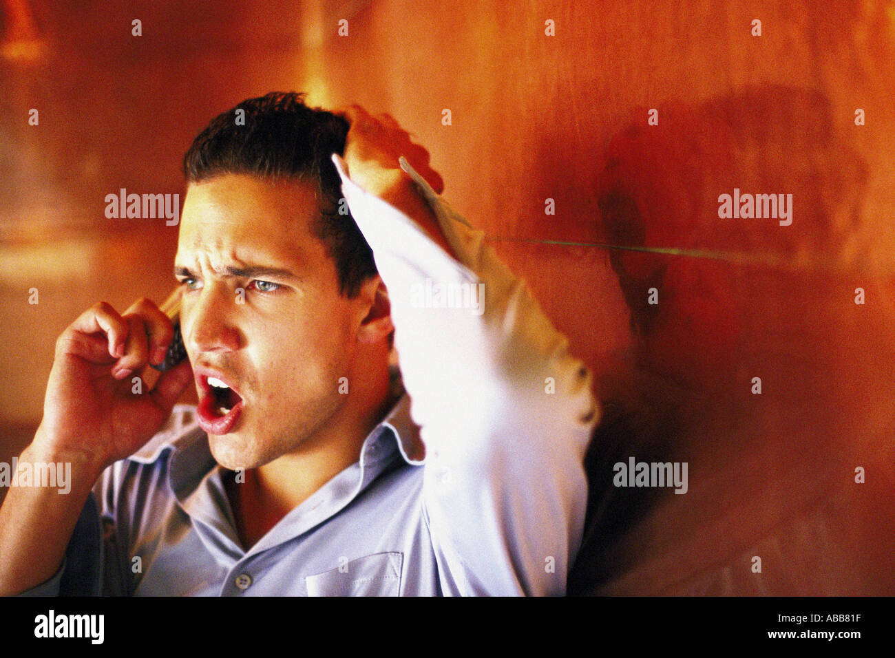 Man talking angrily on cellphone Stock Photo