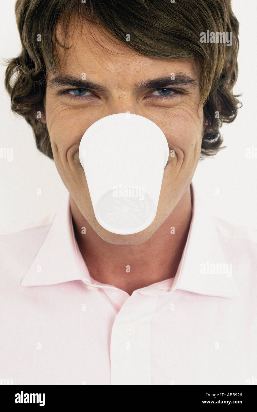 Businessman with plastic cup in mouth Stock Photo Alamy