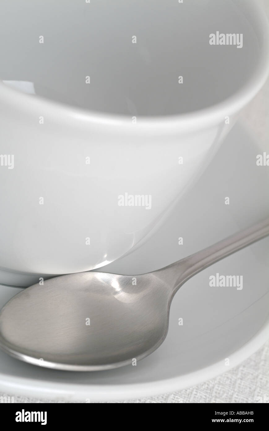 Close Up of an Empty White Cup and Saucer with a Teaspoon Stock Photo