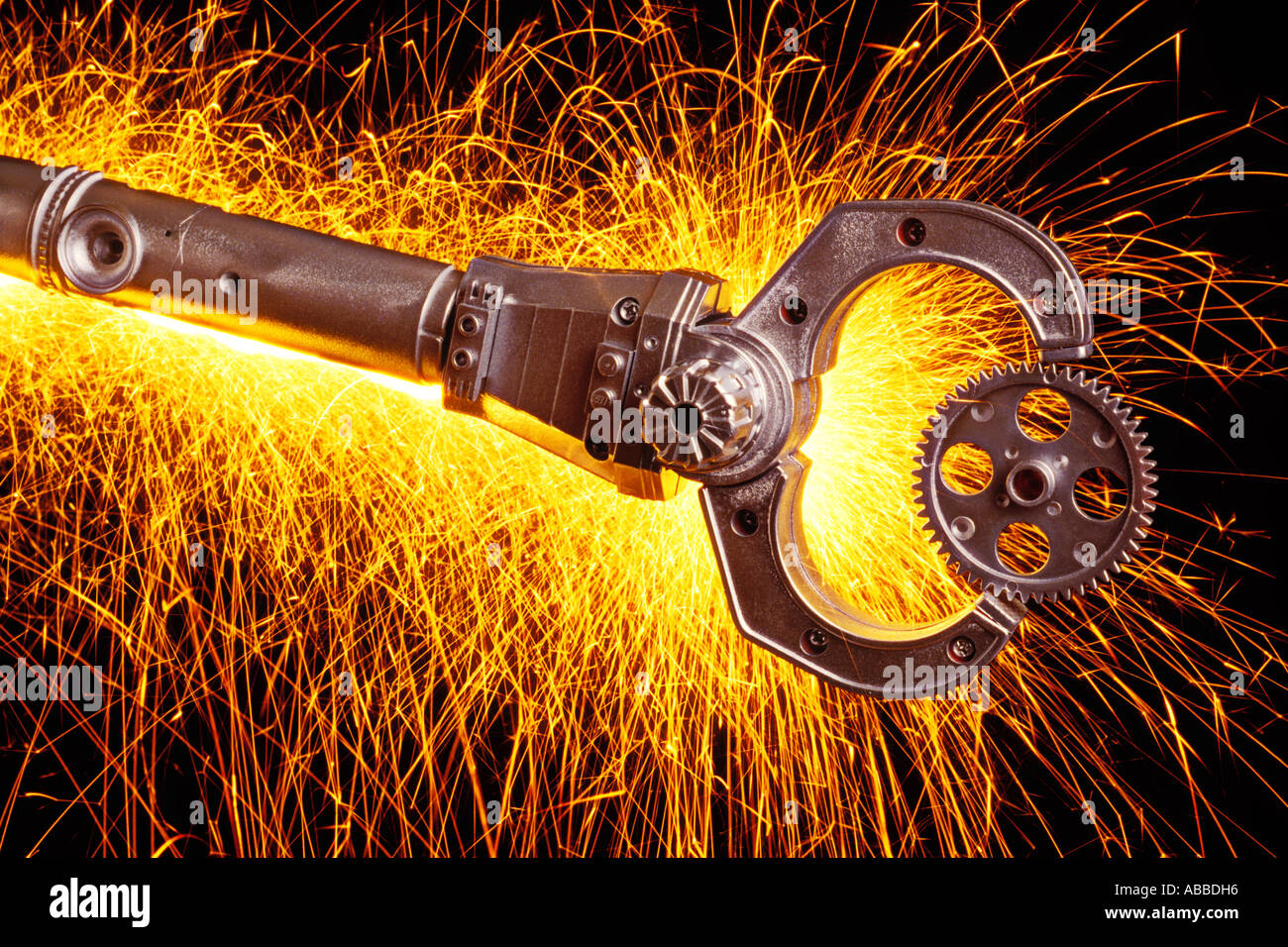 Robot holding gear with background sparks Stock Photo