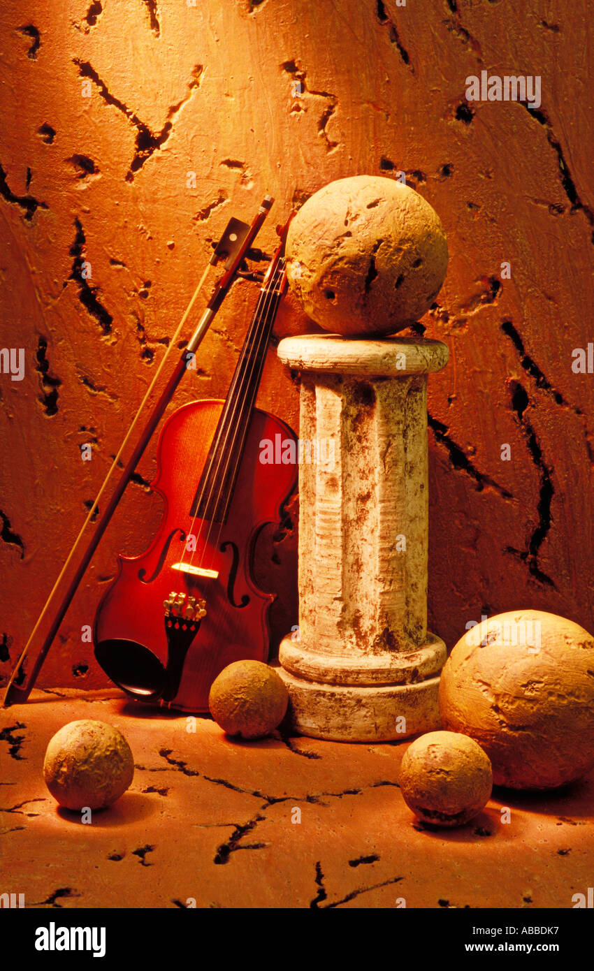 Violin and pedestal with stone balls Stock Photo