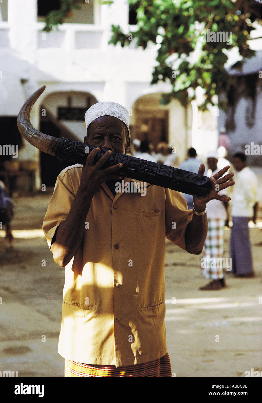 Man playing traditional SIWA or side blown horn Market place Lamu Island Kenya Coast East Africa Stock Photo