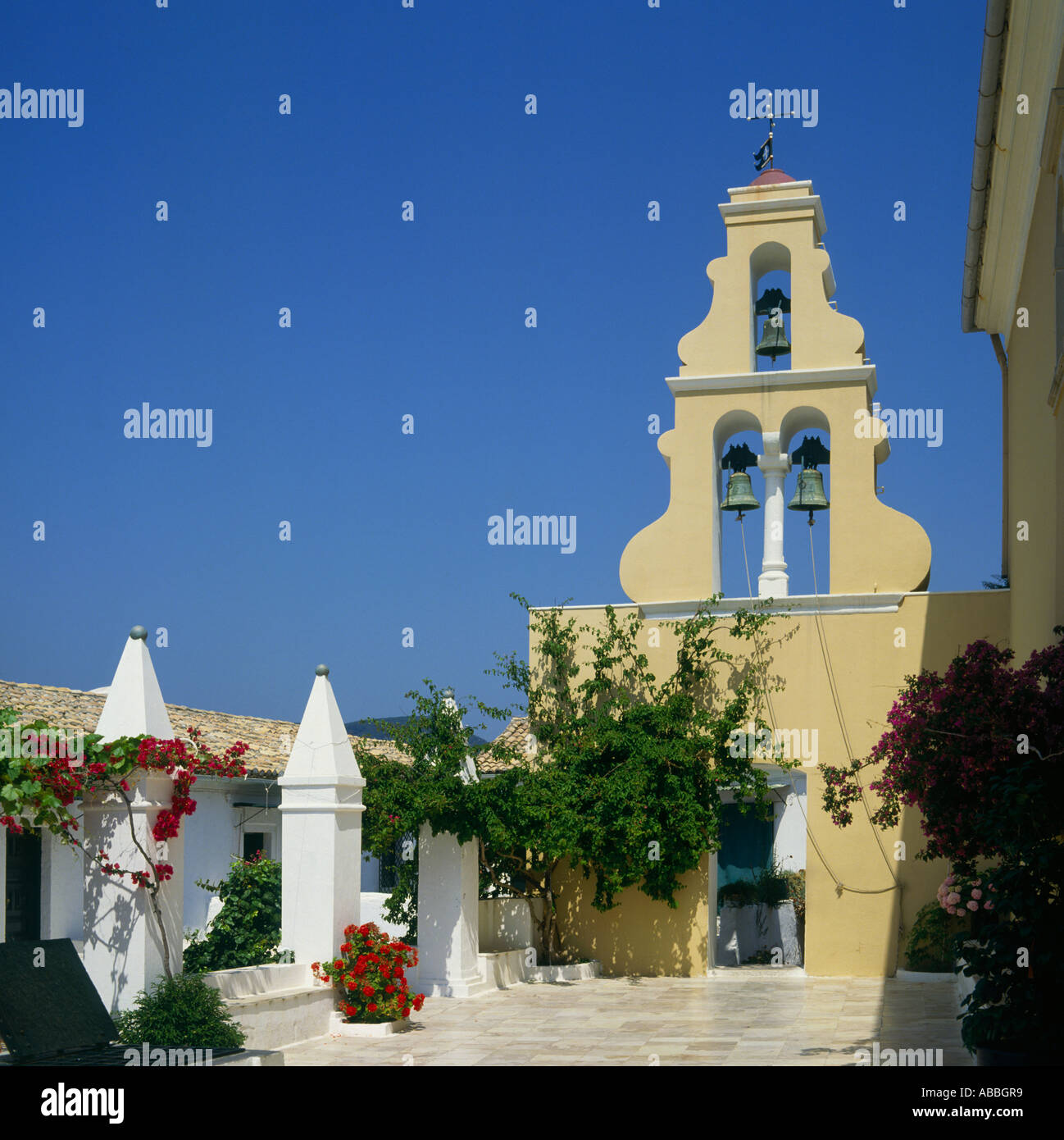 Courtyard and bell tower of the 13th century Monastery with climbing flowers and vines Paleokastritsa Corfu The Greek Islands Stock Photo