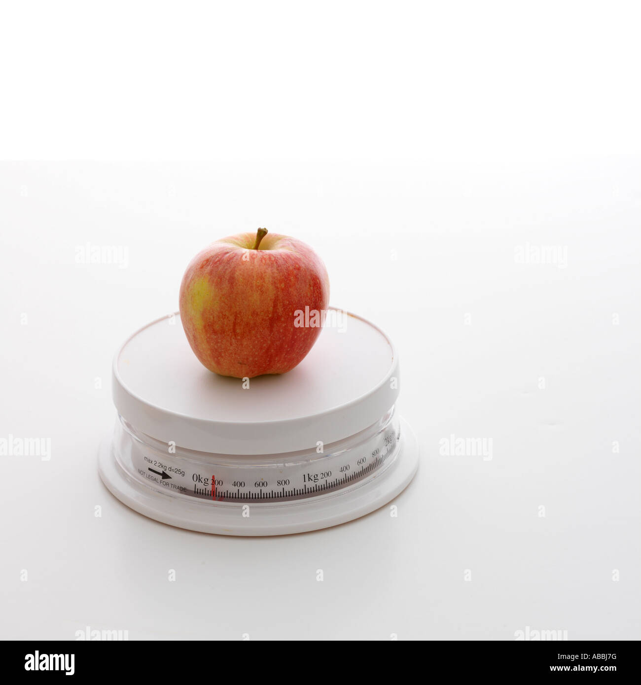 Apple on Weighing Scale Stock Photo - Alamy