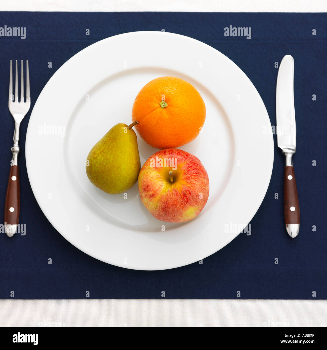 Orange, Pear, Apple Diet on Plate Stock Photo
