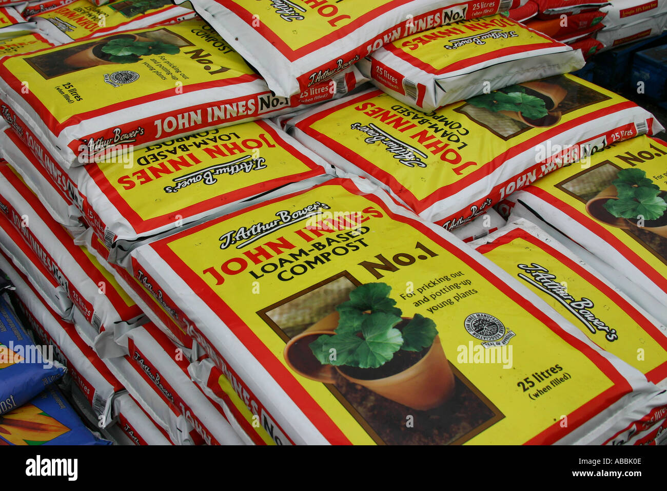 Large number of sacks of commercial potting compost stacked ready for