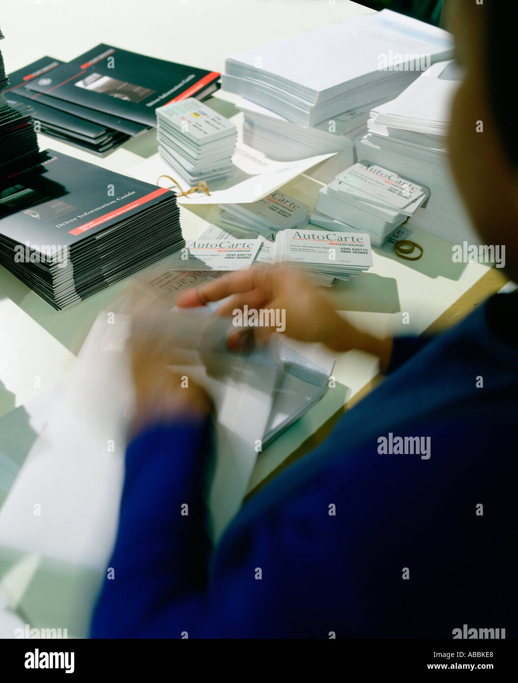Worker stuffing envelopes Stock Photo Alamy