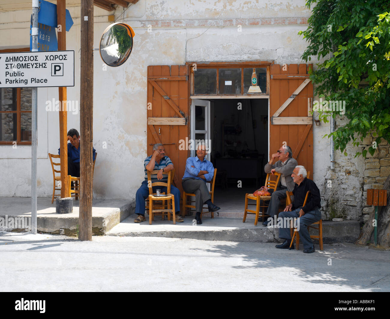 Lefkara Cyprus Men Outside Cafe by Road Sign with Dual Language Stock Photo