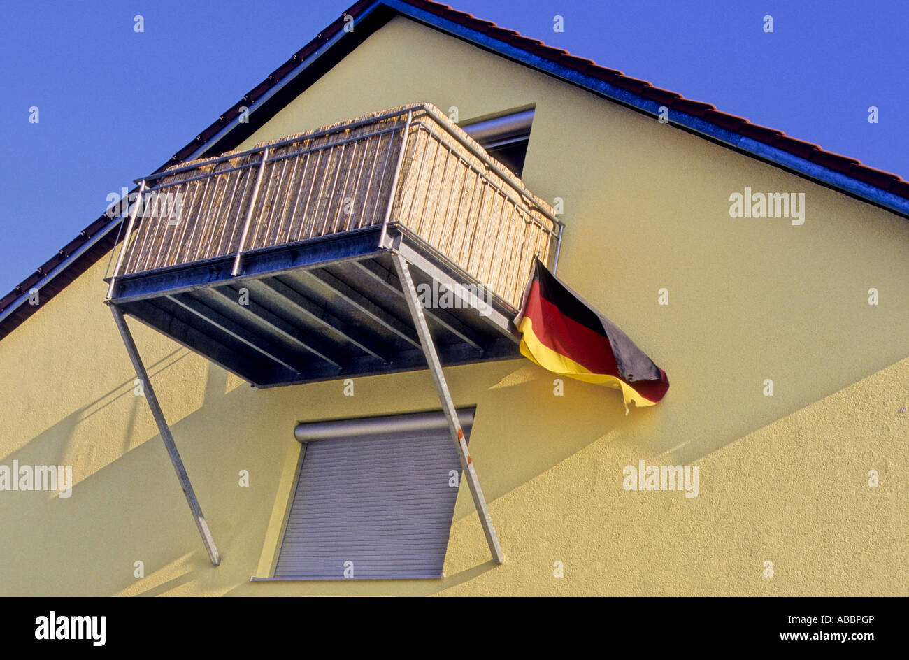 German flat with balcony with German flag flying. Stock Photo