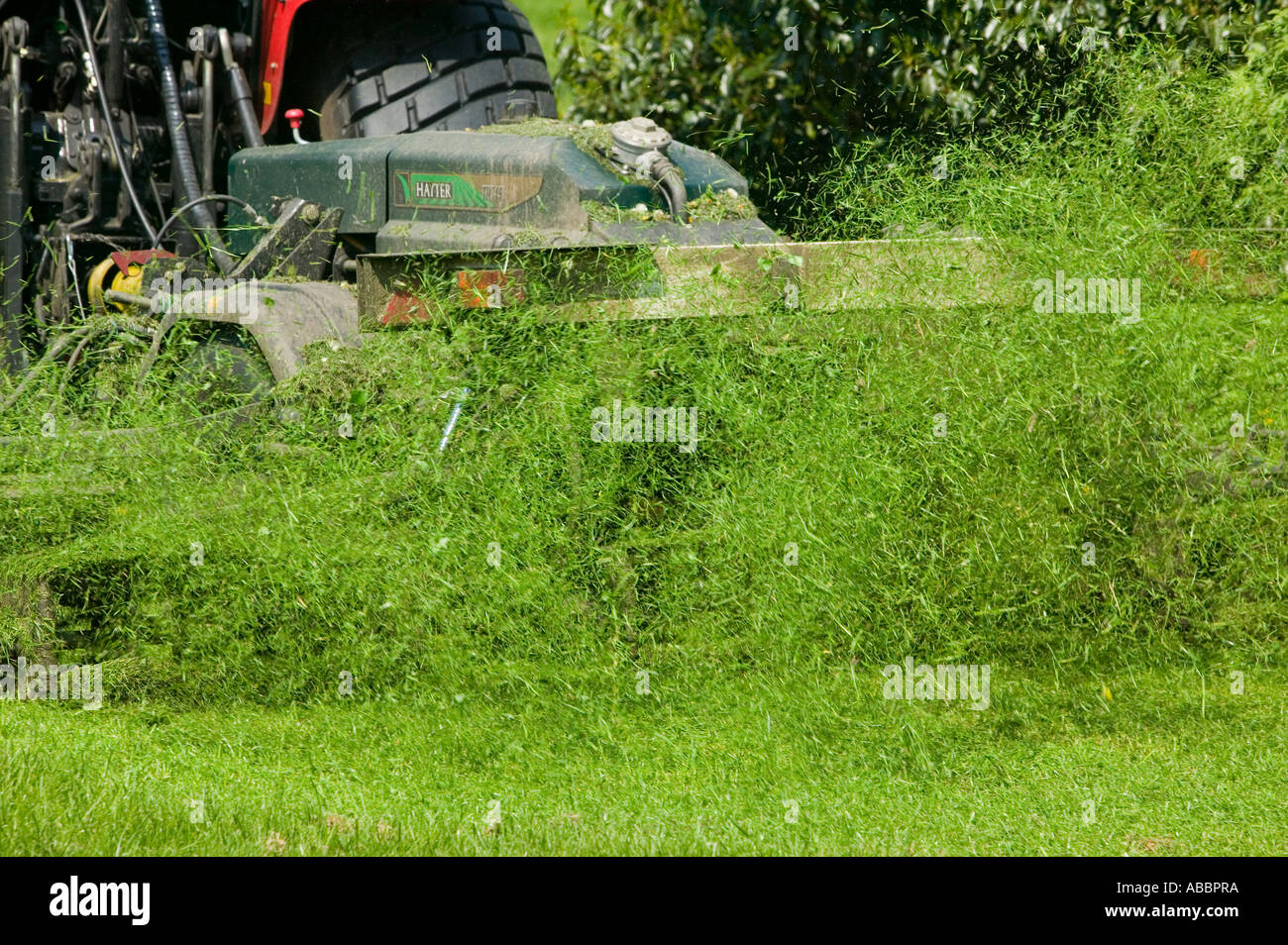 cutting grass with tractor and industrial grass cutting machine, Leicester, Leicestershire, UK Stock Photo