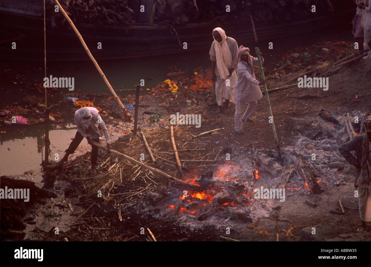 Three people pulling dragging the bones of dead human in Banaras Stock Photo