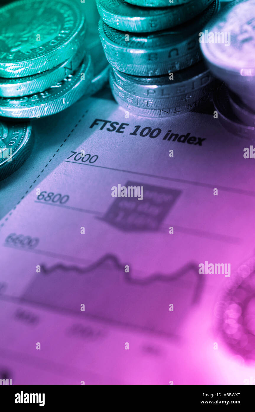 Pound coins on share index report in financial paper Stock Photo