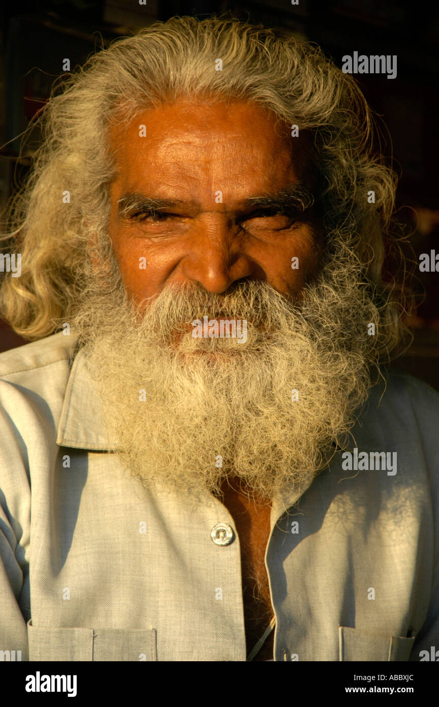 Portrait character man with long gray hair and foll gray beard is smiling mildly Nawalgarh Rajasthan India Stock Photo