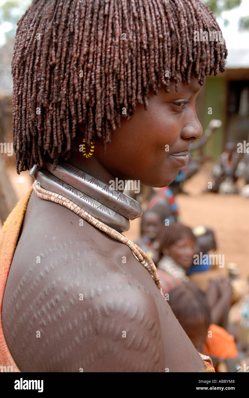 Woman of the Hamar people with typical clay hairdo with decorative scars at the market of Dimeka Ethiopia Stock Photo
