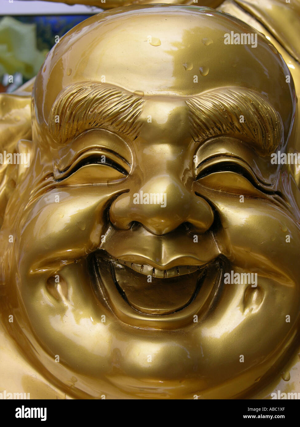 Portrait of a laughing golden Buddah figure Stock Photo
