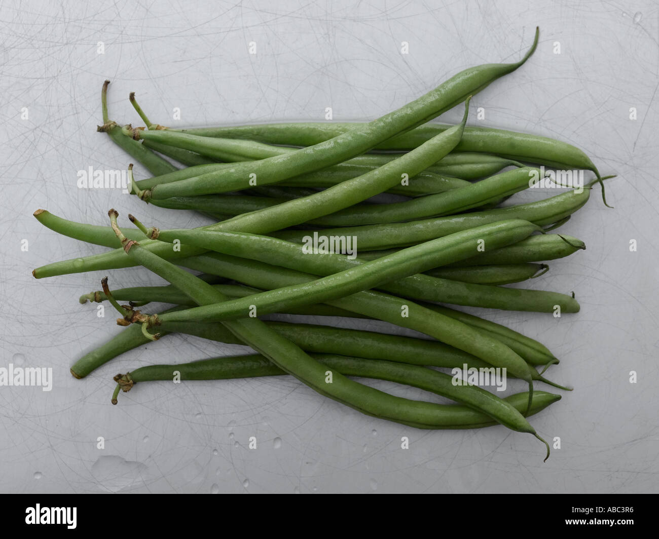 Green beans on metal worktop Stock Photo