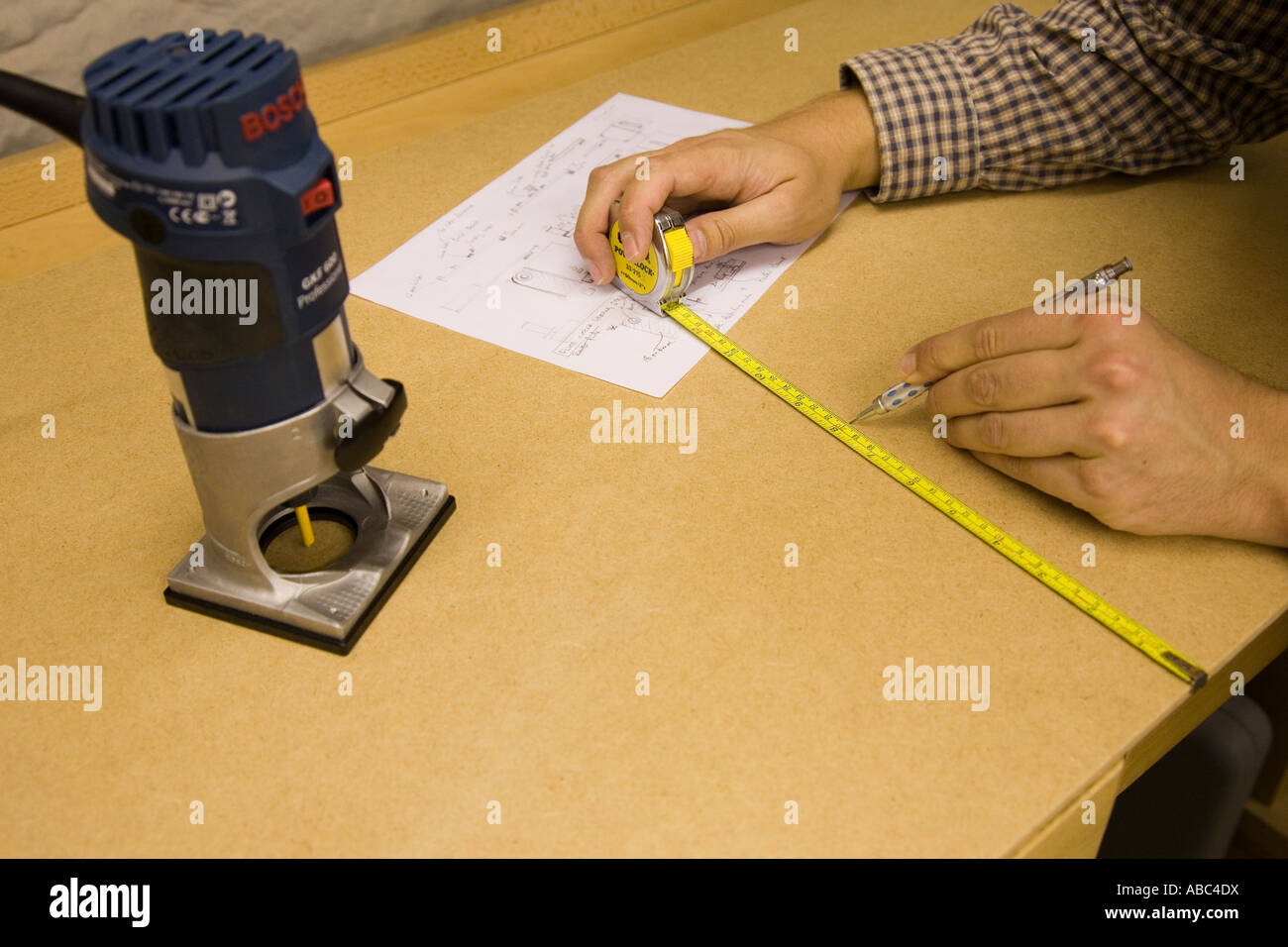 Craftsman marks out a board of MDF ready for routing Stock Photo Alamy
