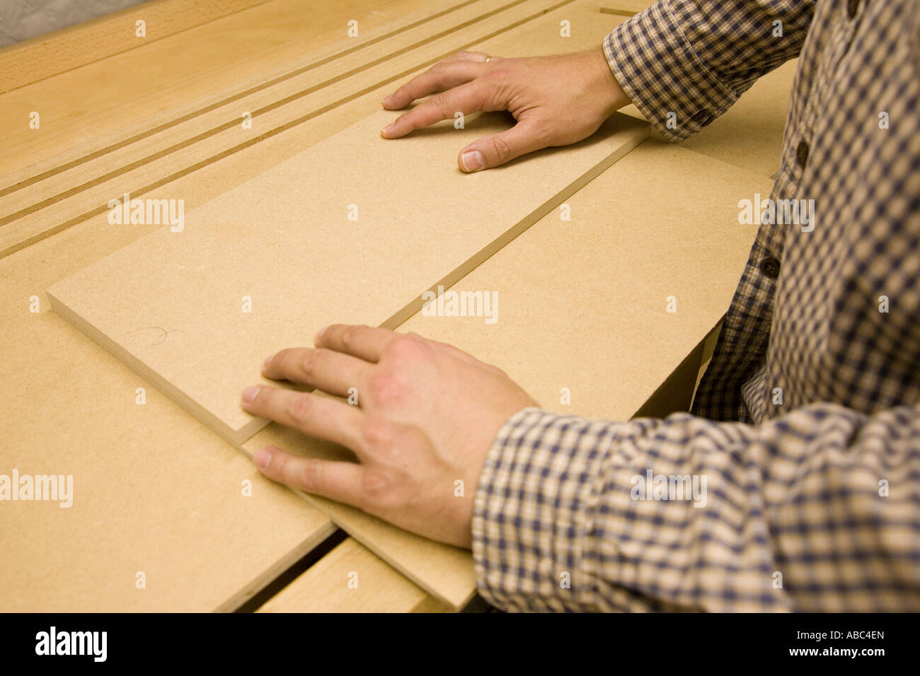 Craftsman creates a rub joint between two peices of MDF Stock Photo Alamy