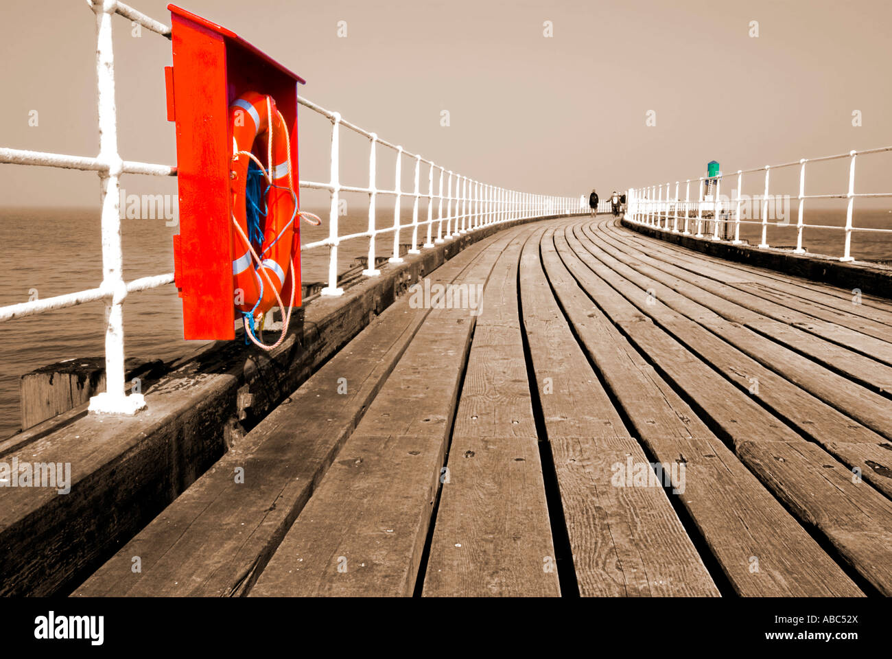 Whitby pier in sepia with red lifebelt Stock Photo