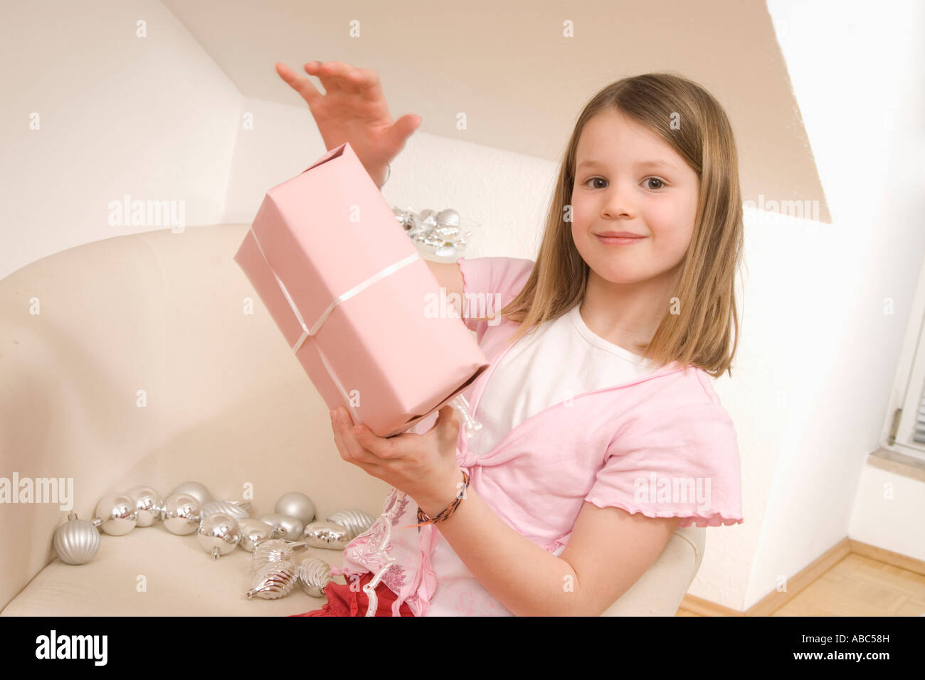 portrait of girl with christmas present Stock Photo - Alamy
