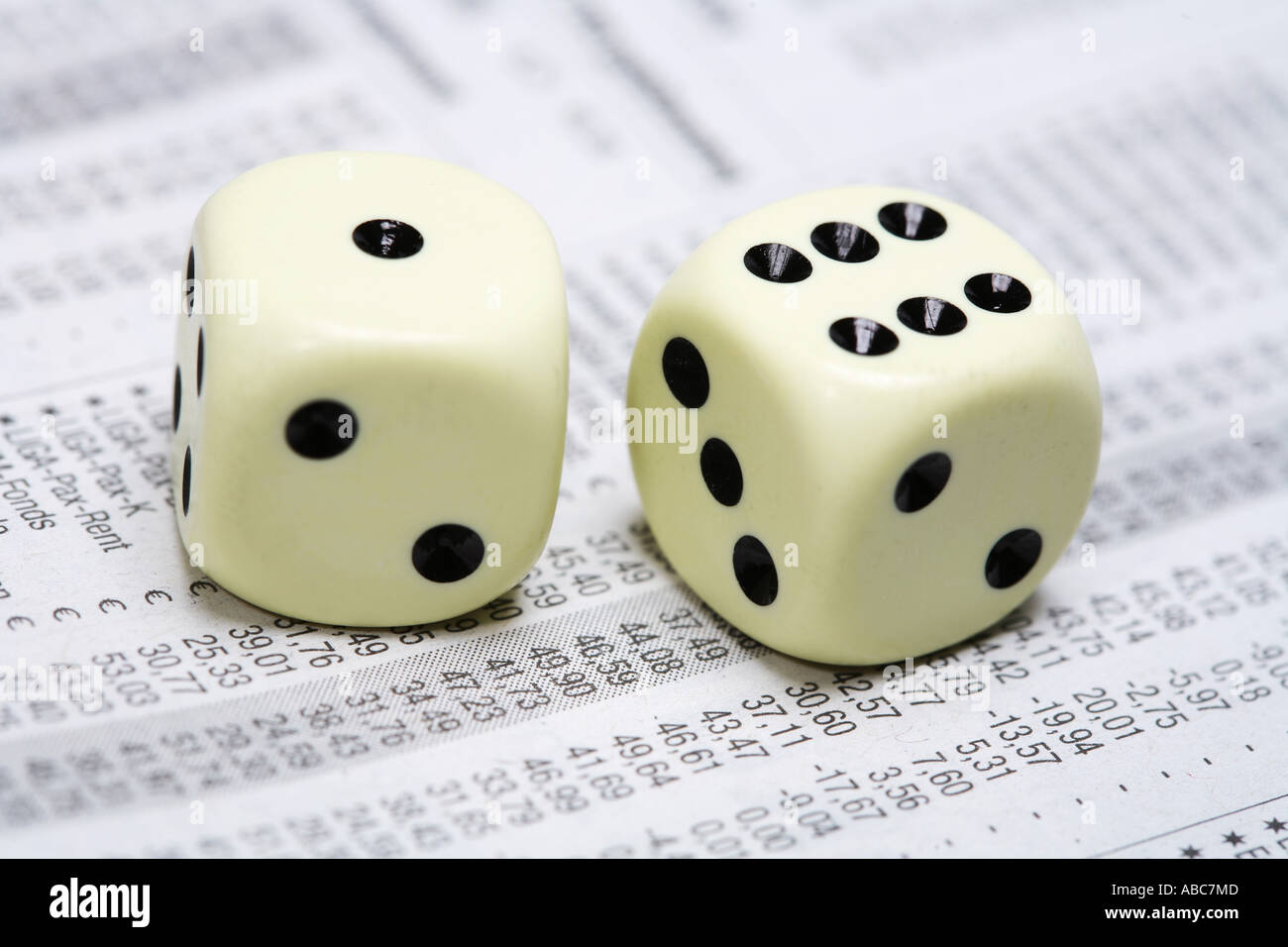 Dices lying on share price chart in a newspaper Stock Photo