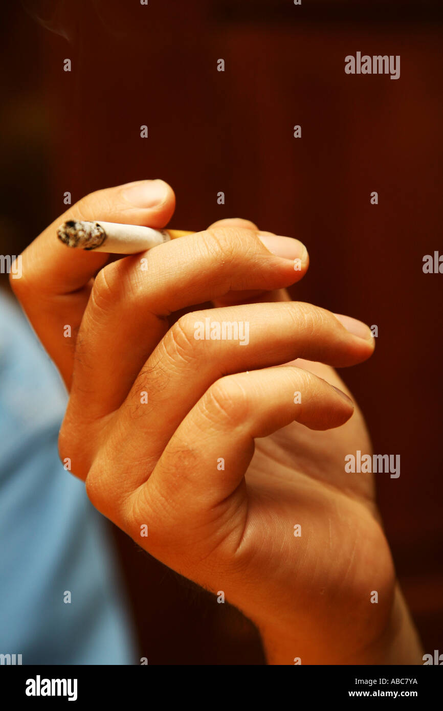 Hand holding a cigarette Stock Photo Alamy