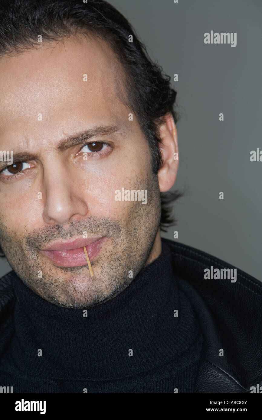 Portrait of a tough guy with bad attitude and a toothpick in his
