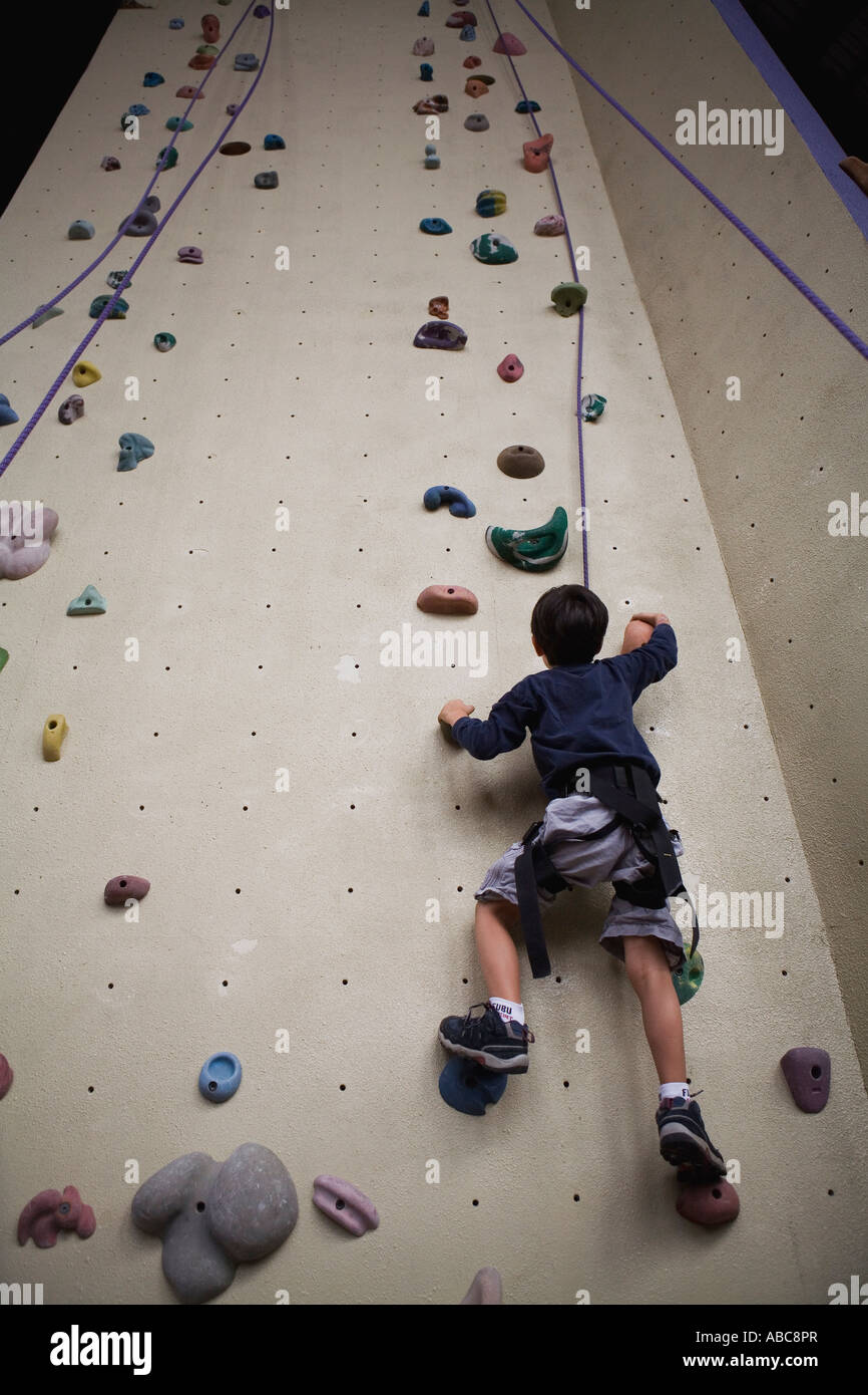 6 year old boy shows bravery and determination while climbing at  challenging indoor rock climbing facility, Model Released Stock Photo -  Alamy