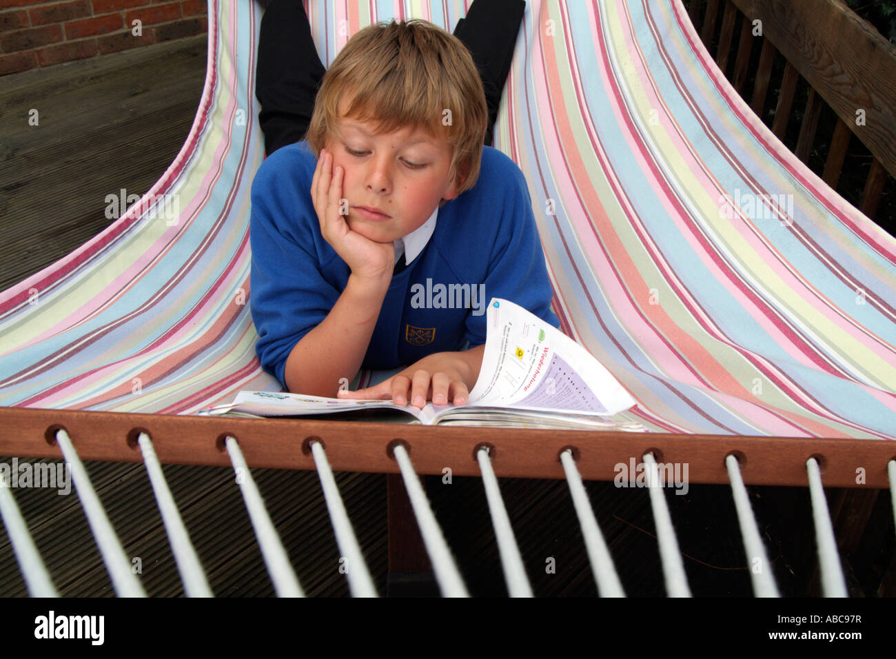 Child reading in a hammock hi-res stock photography and images - Alamy