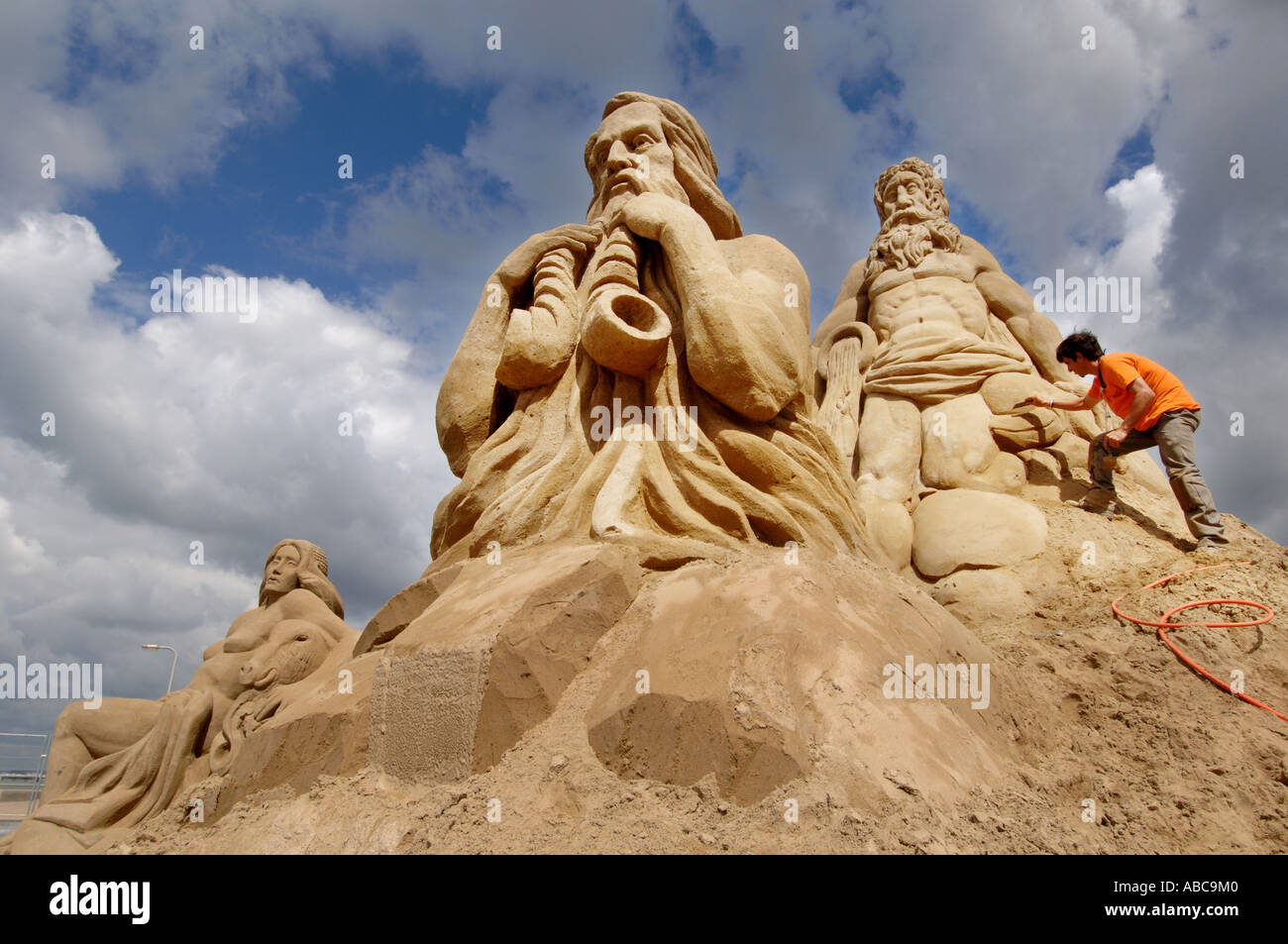 A sand sculptor creates a figures of musicians as part of a display based on the Roman Empire Stock Photo