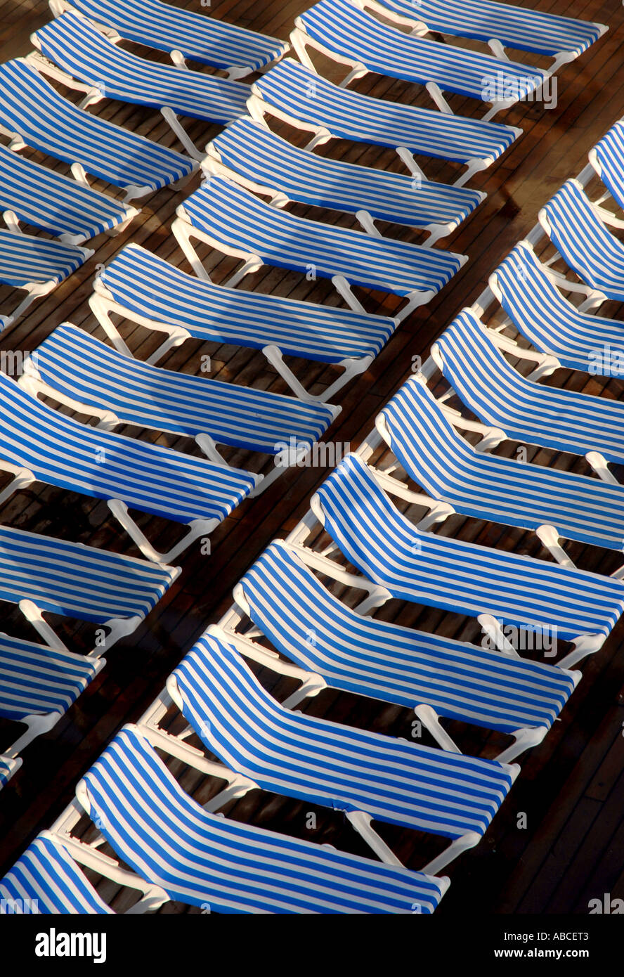 Lounge deck pool chairs empty blue white stripes Stock Photo Alamy