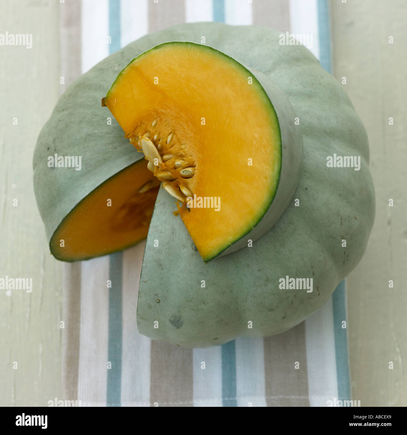 Squash with slice removed on stripey linen cloth Stock Photo