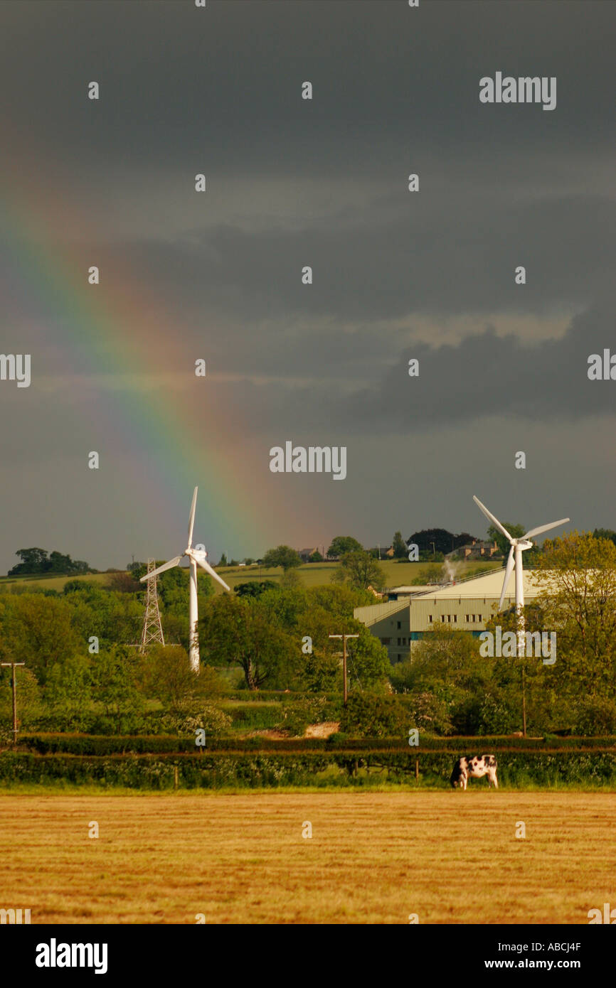Wind Turbines With a Brooding Sky and Rainbow Next to the GSK Factory