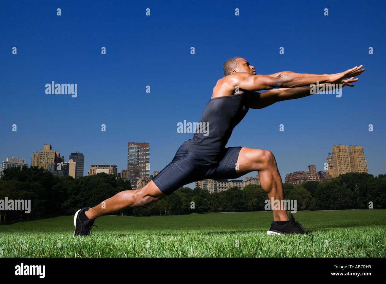Man stretching in central park Stock Photo