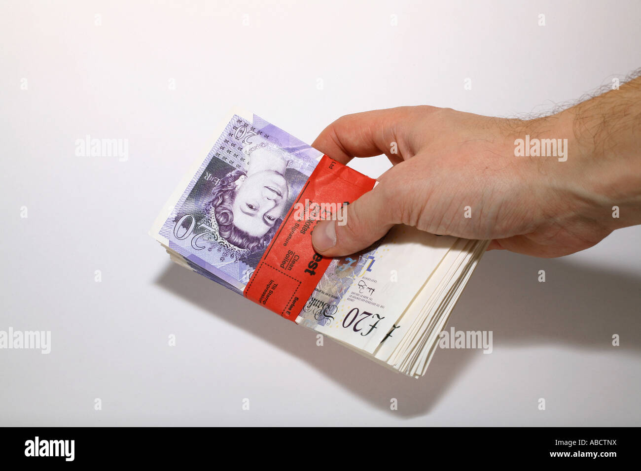 Man with bundle of Twenty pound notes Stock Photo