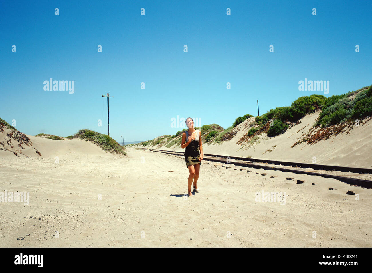 Woman walking into desert hi-res stock photography and images - Alamy