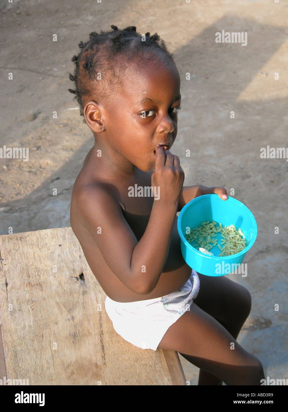 Africa - Nigeria - eating child Stock Photo