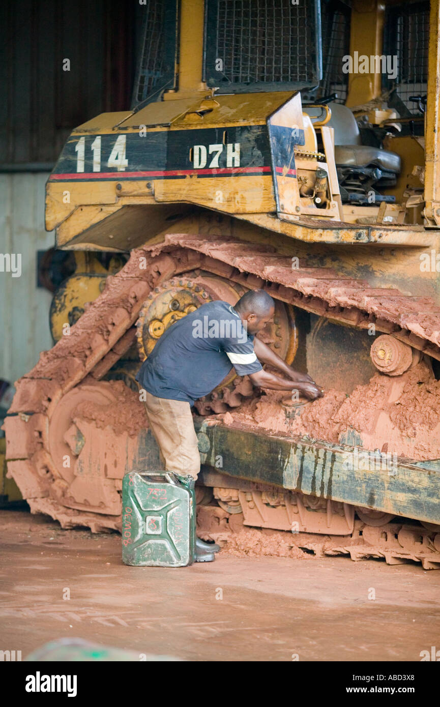 Repairs being made to bulldozer track on logging camp in the rainforest of the Republic of Congo Stock Photo