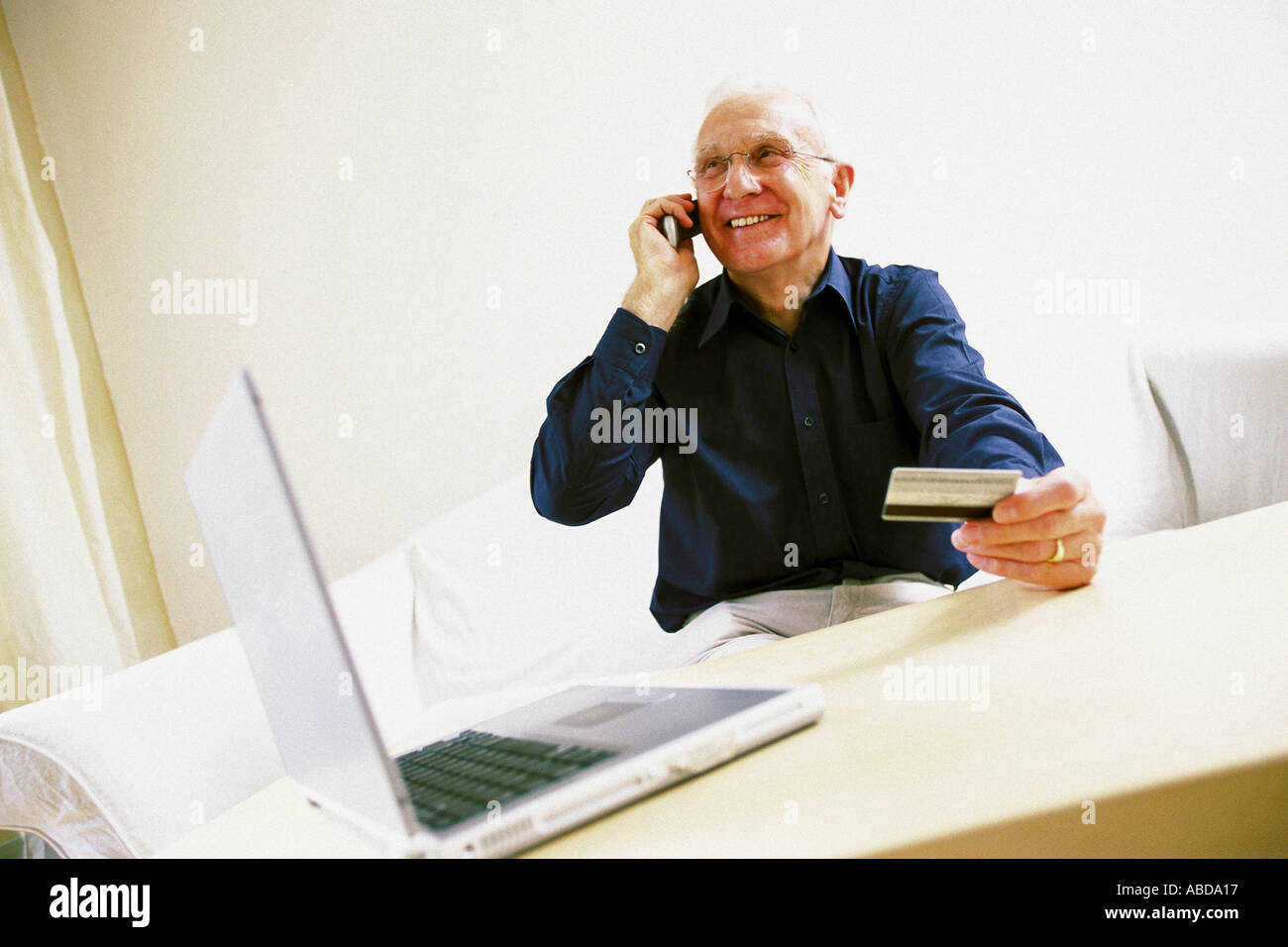 Man using laptop computer and cellphone Stock Photo